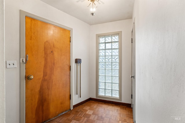 entryway featuring parquet flooring