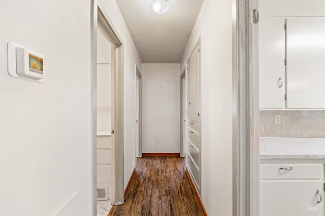 corridor featuring dark wood-type flooring