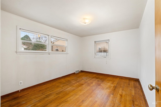 empty room featuring wood-type flooring