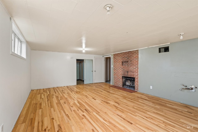 unfurnished living room with a fireplace and light hardwood / wood-style flooring