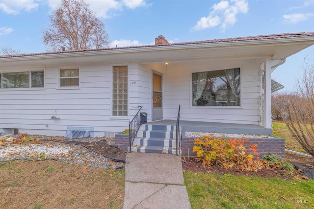 bungalow-style home with a front lawn