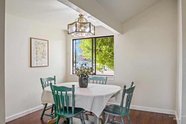dining area featuring baseboards, vaulted ceiling, dark wood-style flooring, and a chandelier