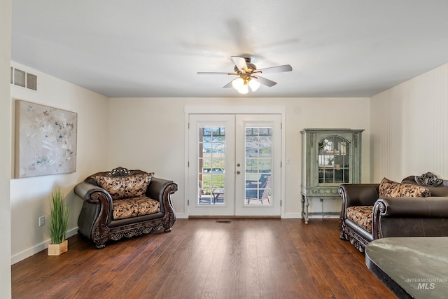 sitting room with french doors, a ceiling fan, baseboards, dark wood-type flooring, and visible vents