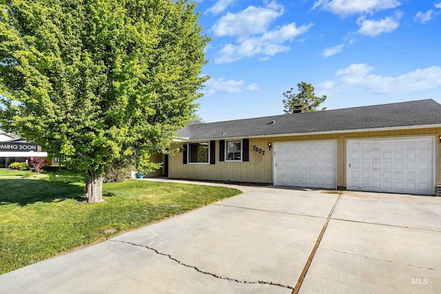 single story home with concrete driveway, a garage, and a front lawn