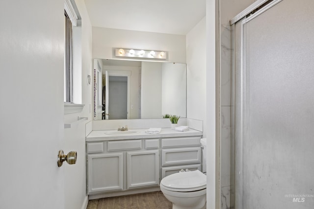 full bathroom featuring vanity, toilet, and wood finished floors