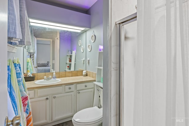 bathroom featuring vanity, connected bathroom, a stall shower, and toilet