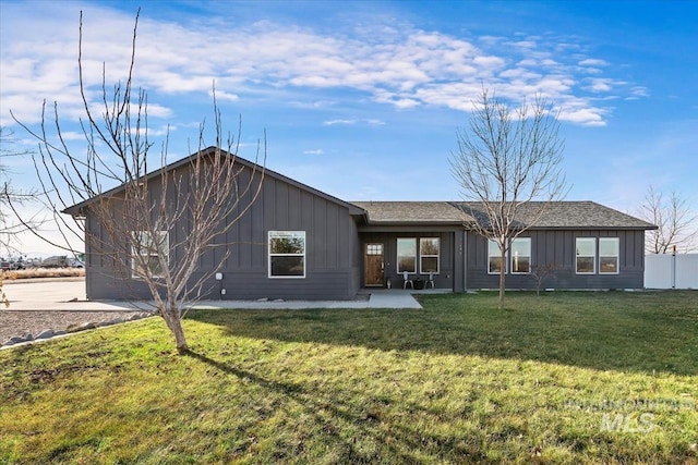 back of property featuring a yard and a patio