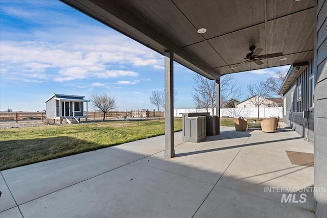 view of patio / terrace with ceiling fan and a storage shed