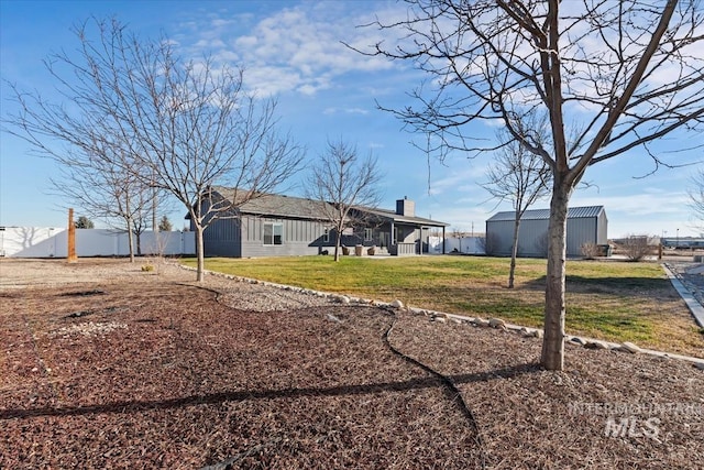 rear view of house with a yard