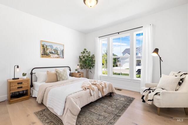 bedroom featuring light wood-style flooring and baseboards