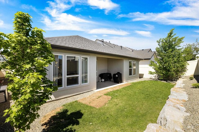 back of property featuring stucco siding and roof with shingles