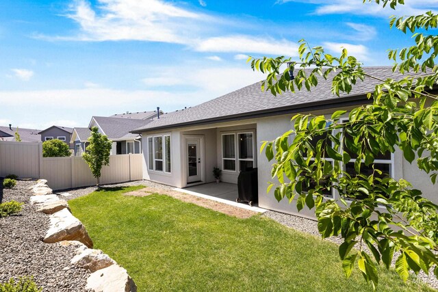 back of property featuring stucco siding and roof with shingles