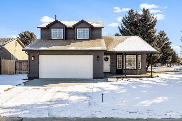 traditional home with fence and an attached garage