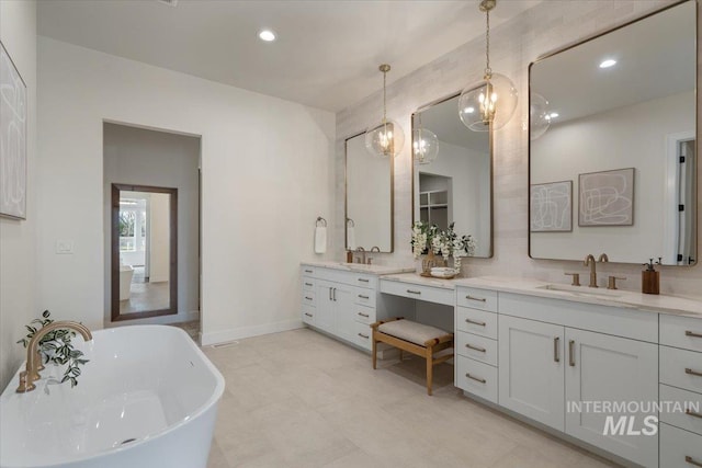 full bath with a soaking tub, recessed lighting, vanity, and baseboards