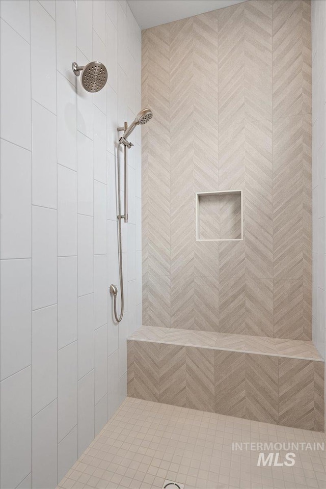 bathroom with tiled shower