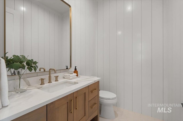 bathroom featuring toilet and vanity