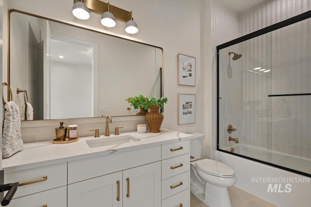 bathroom with vanity, toilet, and enclosed tub / shower combo