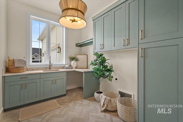 washroom featuring cabinet space, electric dryer hookup, and a sink