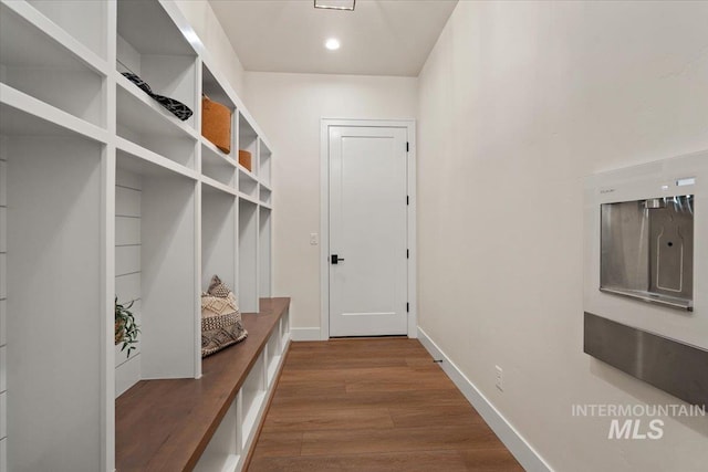 mudroom featuring baseboards and wood finished floors