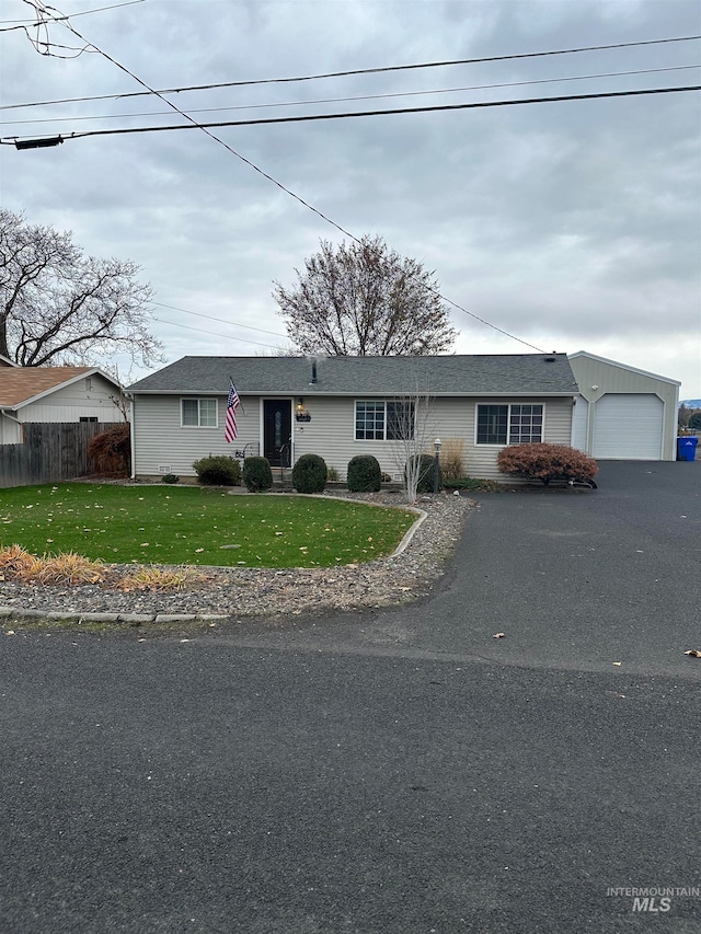 single story home featuring a front yard and a garage