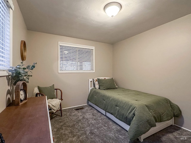 bedroom with dark carpet