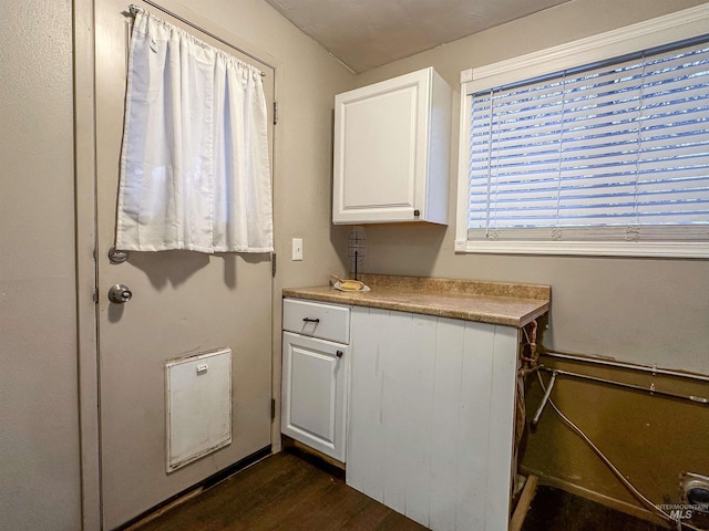 kitchen featuring white cabinetry and dark wood-type flooring