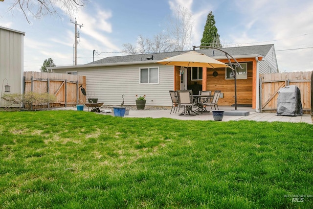 rear view of property with a lawn and a patio area