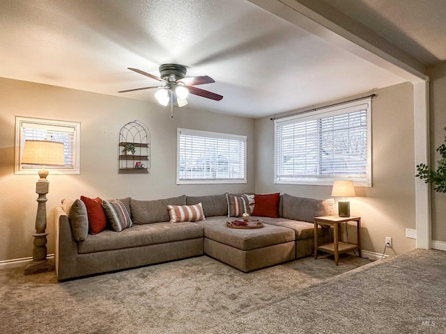 carpeted living room with ceiling fan