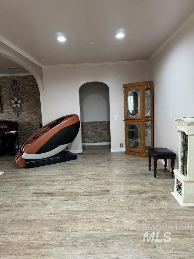 sitting room with light hardwood / wood-style floors and ornamental molding