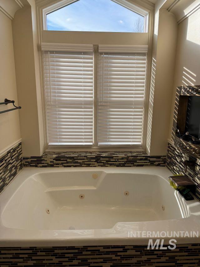 bathroom with a relaxing tiled tub