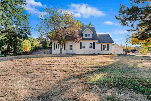 cape cod-style house with a front lawn