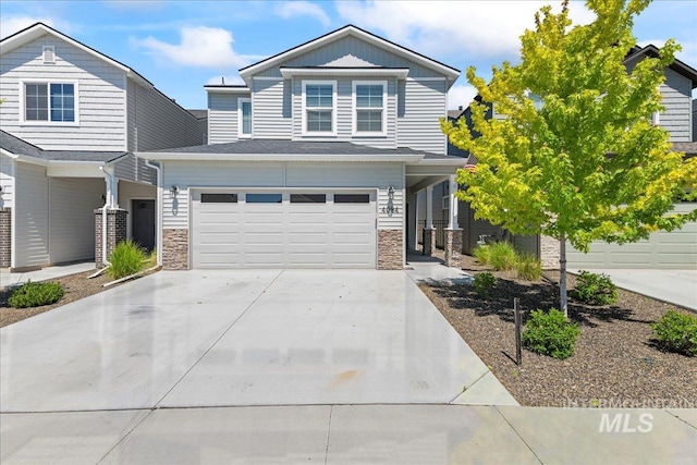 4084 E Blueberry St, Meridian, ID 83642 - view of front facade with stone siding, concrete driveway, and a garage