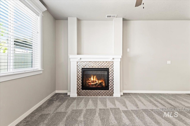 4084 E Blueberry St, Meridian, ID 83642 - unfurnished living room with carpet floors, a tile fireplace, baseboards, and ceiling fan