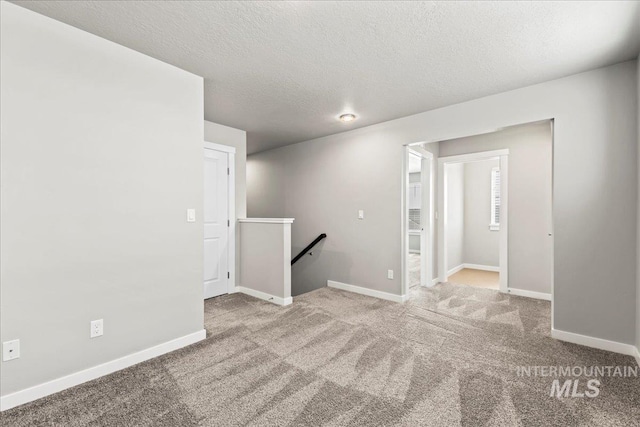 4084 E Blueberry St, Meridian, ID 83642 - carpeted empty room with baseboards and a textured ceiling