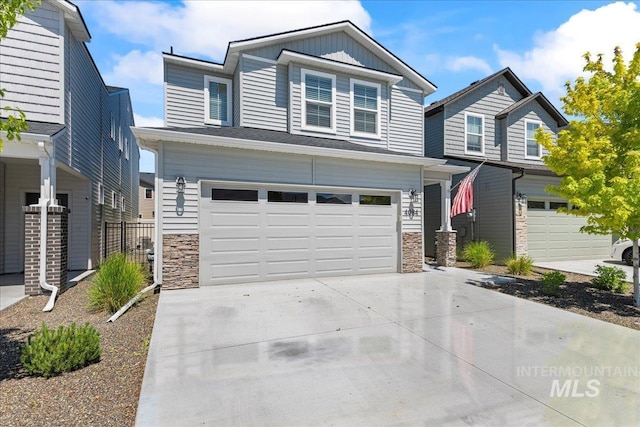 4084 E Blueberry St, Meridian, ID 83642 - view of front facade with an attached garage, stone siding, driveway, and board and batten siding