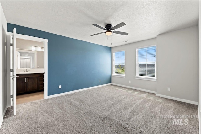 4084 E Blueberry St, Meridian, ID 83642 - unfurnished bedroom with light carpet, a textured ceiling, baseboards, and ensuite bath