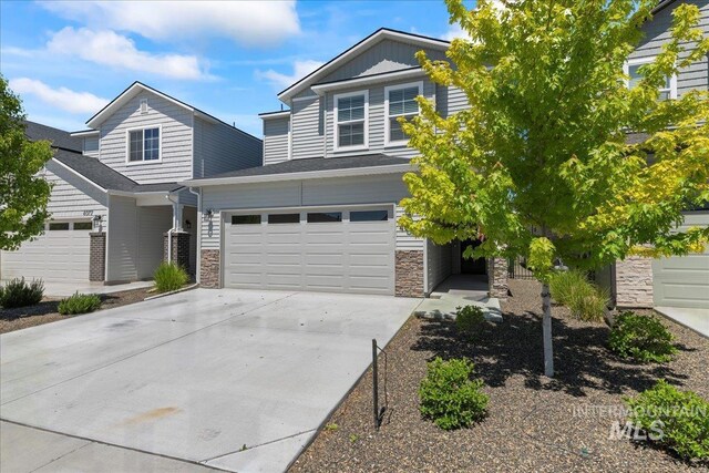 4084 E Blueberry St, Meridian, ID 83642 - view of front facade featuring stone siding, concrete driveway, and an attached garage