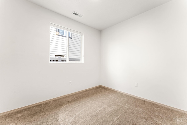 unfurnished room featuring baseboards, visible vents, and carpet floors