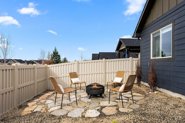 view of patio / terrace featuring a fenced backyard and an outdoor fire pit