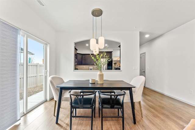 dining area with a notable chandelier, recessed lighting, visible vents, and light wood finished floors