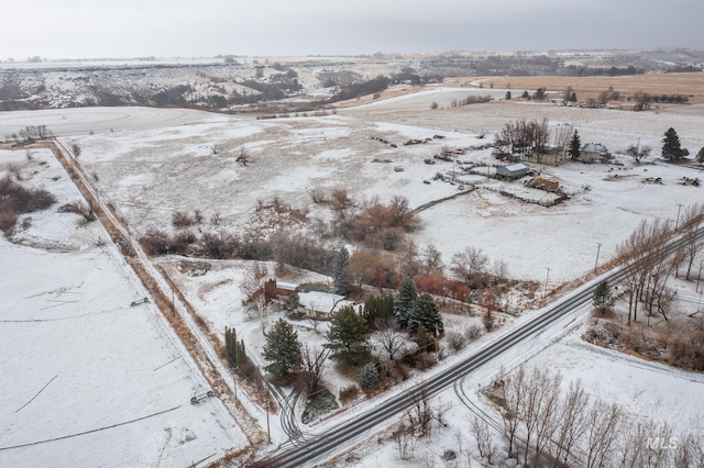 snowy aerial view featuring a rural view