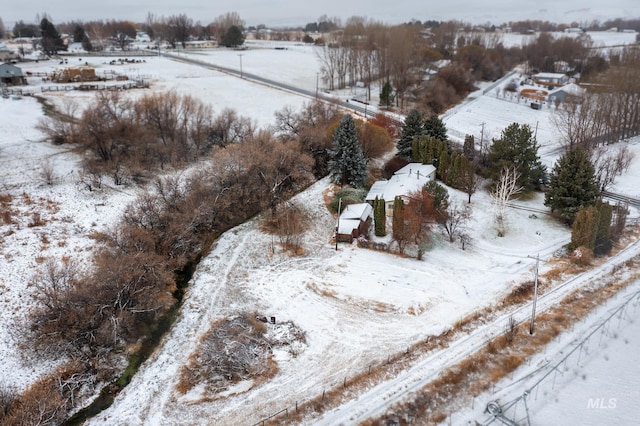 snowy aerial view featuring a rural view