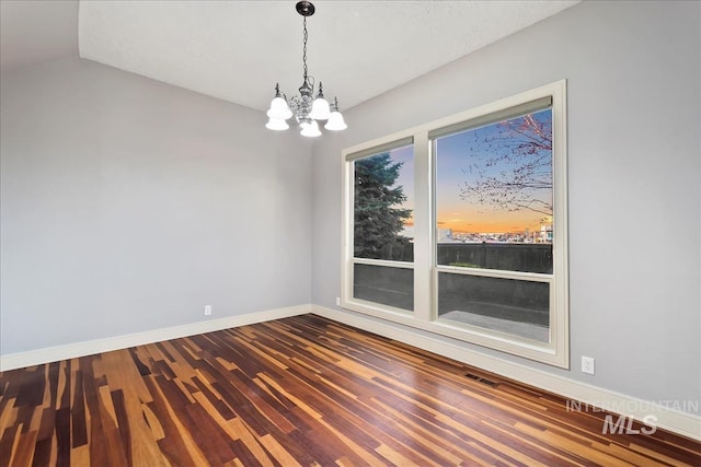 1280 W Bacall St, Meridian, ID 83646 - empty room featuring vaulted ceiling, baseboards, visible vents, a notable chandelier, and dark wood-type flooring