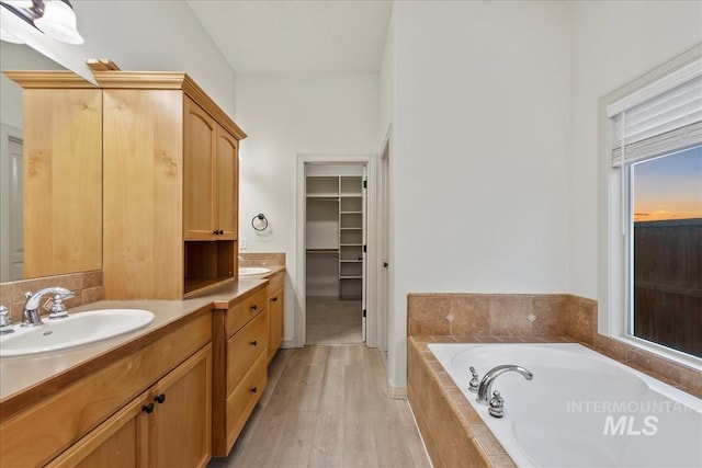 1280 W Bacall St, Meridian, ID 83646 - full bath with a sink, a bath, a walk in closet, double vanity, and wood finished floors