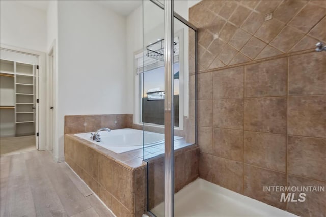 1280 W Bacall St, Meridian, ID 83646 - bathroom featuring a walk in closet, a stall shower, wood finished floors, and a bath