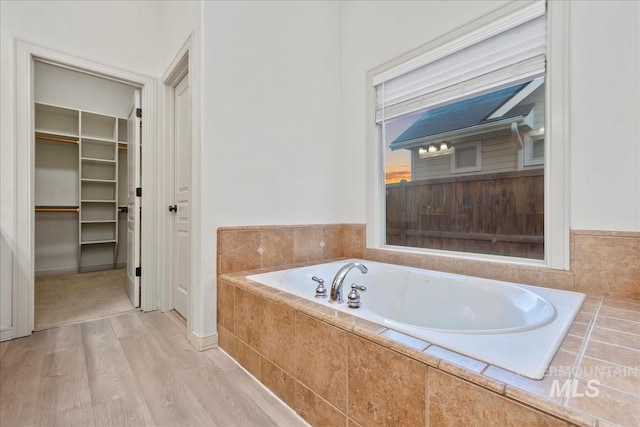 1280 W Bacall St, Meridian, ID 83646 - full bathroom featuring wood finished floors, a bath, and a walk in closet