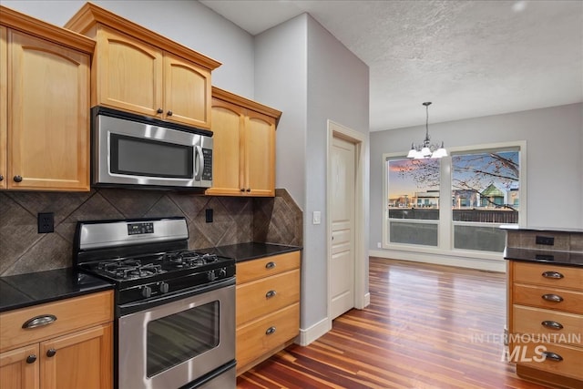 1280 W Bacall St, Meridian, ID 83646 - kitchen with wood finished floors, dark countertops, stainless steel appliances, and a notable chandelier