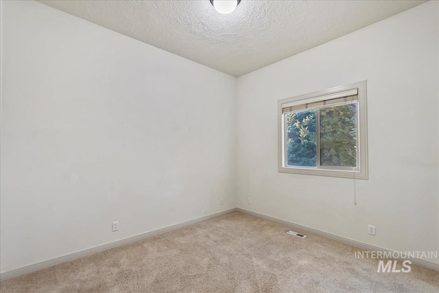 1280 W Bacall St, Meridian, ID 83646 - carpeted empty room with baseboards, visible vents, and a textured ceiling