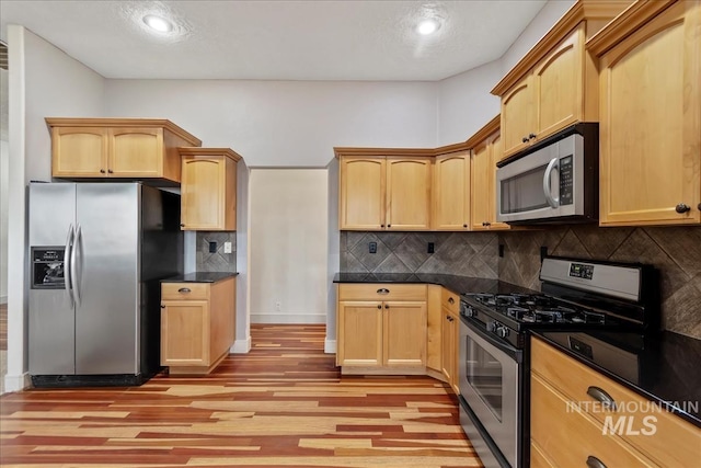 1280 W Bacall St, Meridian, ID 83646 - kitchen featuring light wood finished floors, dark countertops, backsplash, and stainless steel appliances