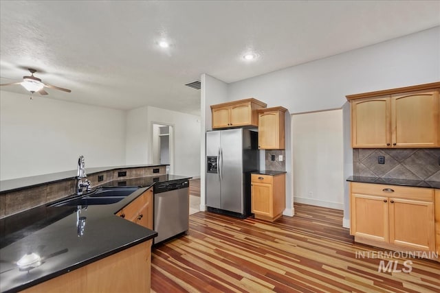 1280 W Bacall St, Meridian, ID 83646 - kitchen featuring stainless steel appliances, backsplash, a ceiling fan, and a sink